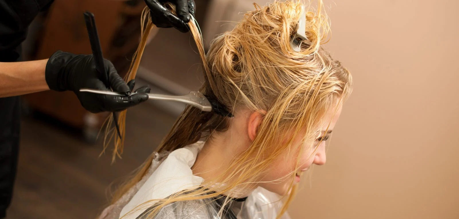 woman getting her roots dyed