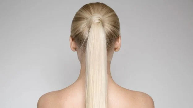 back view of a women head with a ponytail
