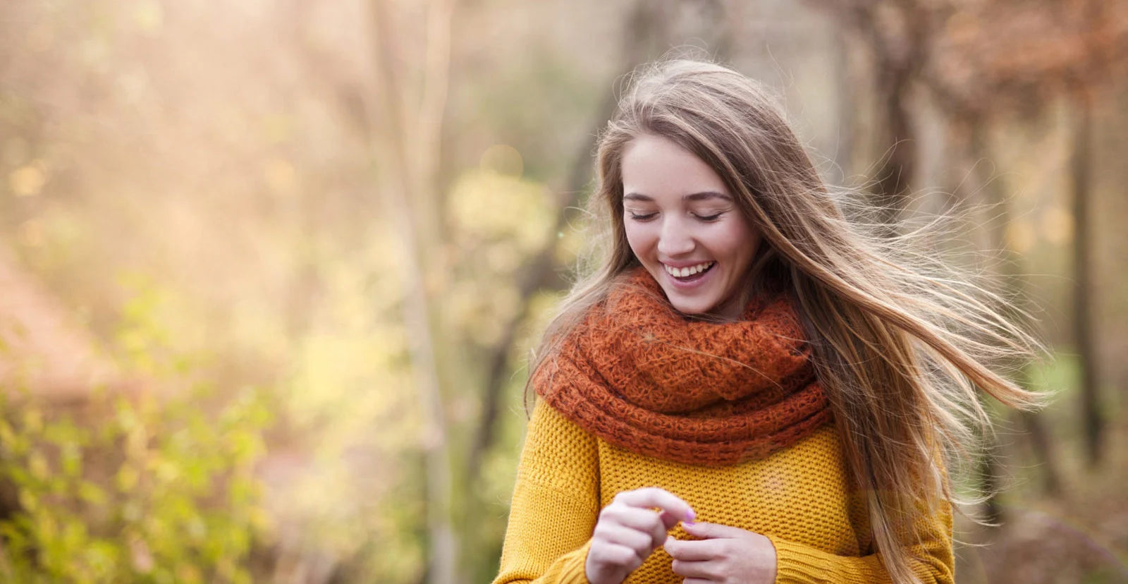 woman smiling outdoor during the fall month