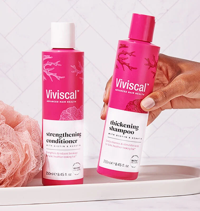Viviscal thickening shampoo and strengthening conditioner on the counter