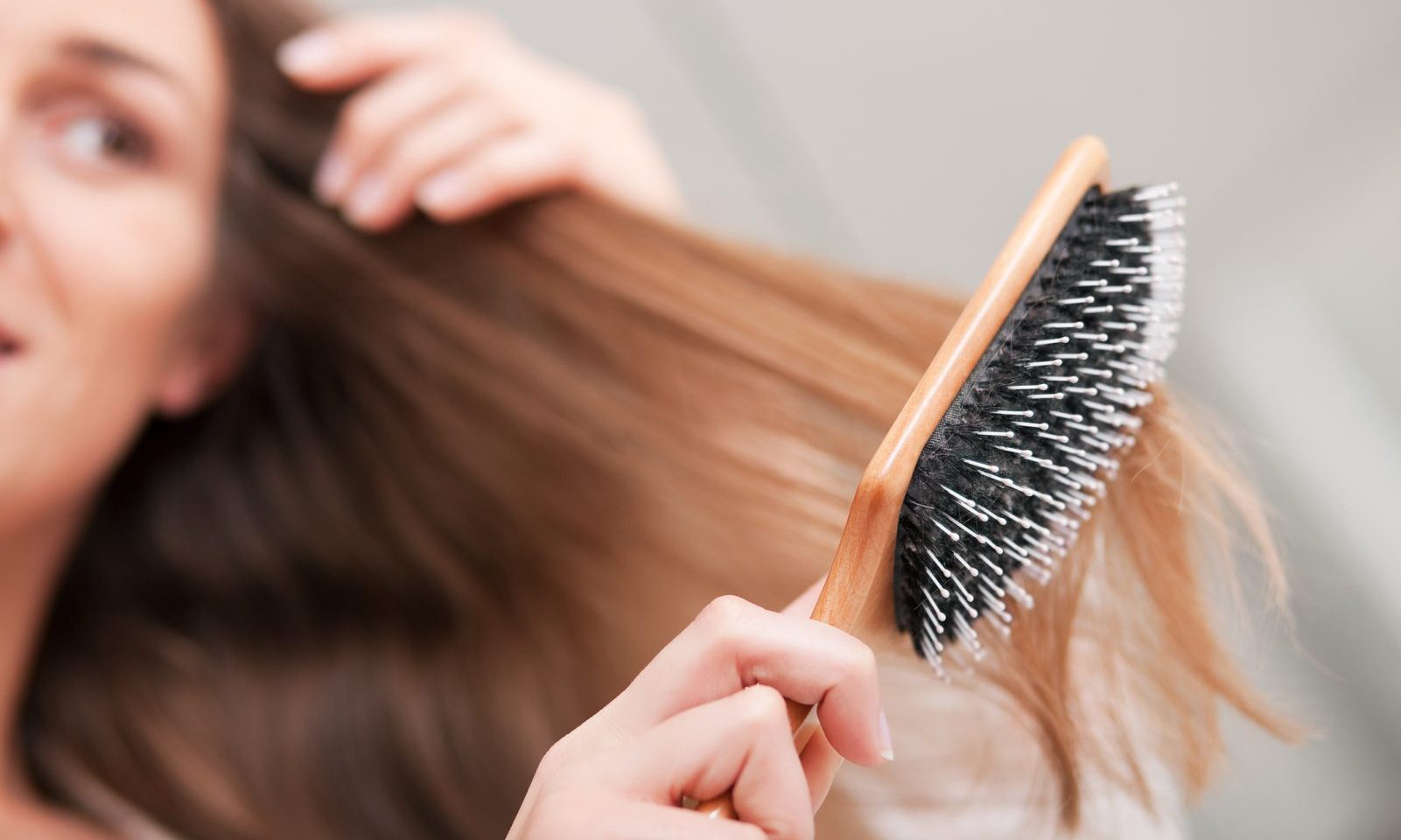 woman brushing her hair 