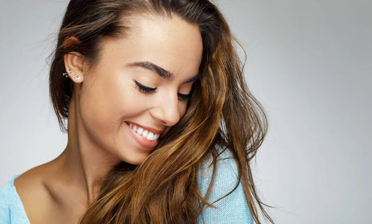 a woman smiling with her volumized hair