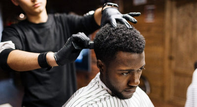 man getting a haircut at the barber
